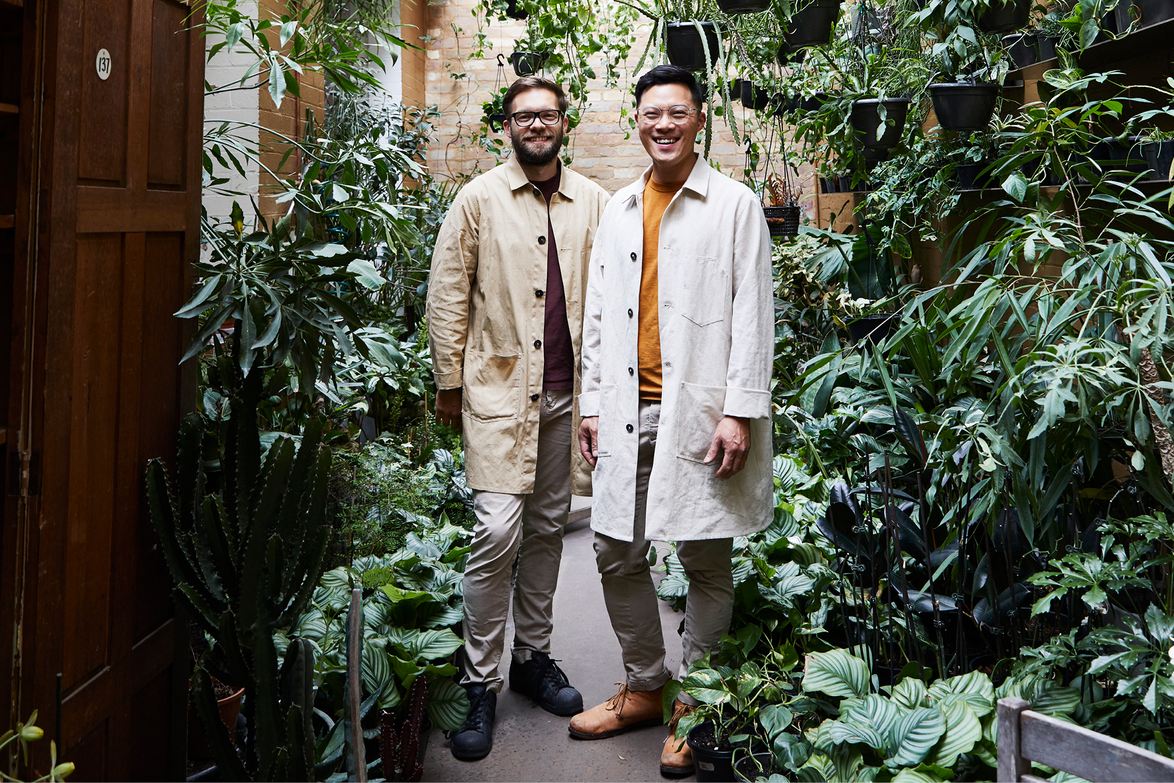 Nathan Smith and Jason Chongue from The Plant Society stand amongst the many plants within their store.